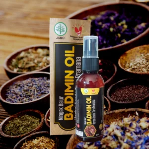 Botol dan kemasan BADIMIN OIL, minyak urut herbal khas Bali untuk rematik dan pegal, difoto dengan latar ramuan herbal alami.
